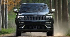 A black 2019 Jeep Grand Cherokee driving on a highway in Sheboygan, WI