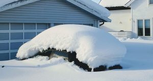 A car parked in the driveway covered in snow in Sheboygan, WI