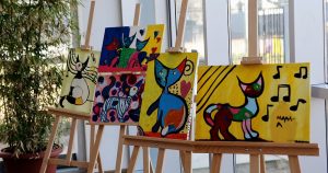 Paintings on display at a local art exhibit in Sheboygan, WI