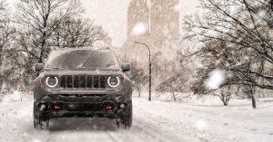 A gray 2020 Jeep Renegade driving through the snow in Sheboygan, WI