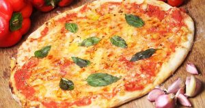 A Neapolitan pizza with basil leaves served by a local pizza restaurant in Sheboygan, WI